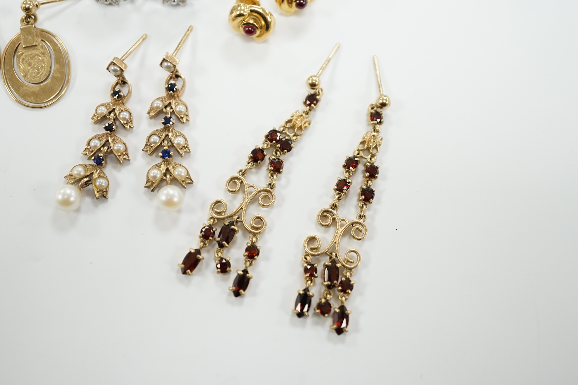 Three pairs of assorted 9ct gold earrings including two gem set, a pair of white metal (stamped 18) and gem set ear clips and a pair of 18k and cabochon ruby ear studs.